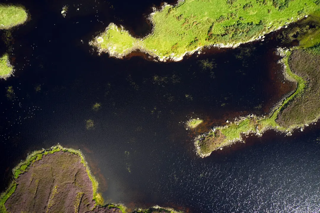 Green islands and dark water seen from the air over South Uist